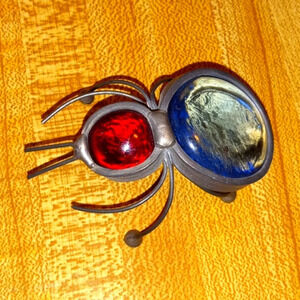 spider/bug made of silver, red glass and light blue glass